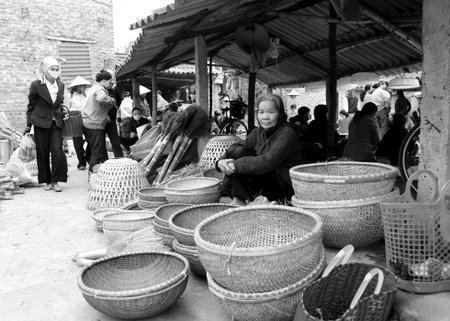 HAI DUONG, VIETNAM, APRIL, 10: Asian woman selling bamboo basket at market on April, 10  in Hai Duong, Vietnam. のeditorial素材