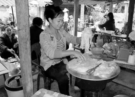 HAI DUONG, VIETNAM, APRIL, 10: Asian woman selling rice cake in the market on April, 10  in Hai Duong, Vietnam. のeditorial素材