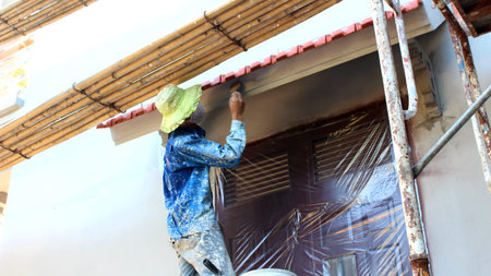 HAI DUONG, VIETNAM, JULY, 28: Painter painting wall in home on july, 28, 2014 in Hai Duong, Vietnamのeditorial素材