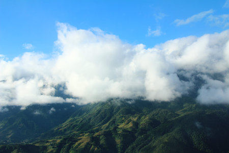 Mountain landscape with clouds and blue sky, closeup of photo