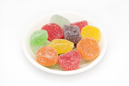Colorful candy with sugar on top in a small white plateの写真素材
