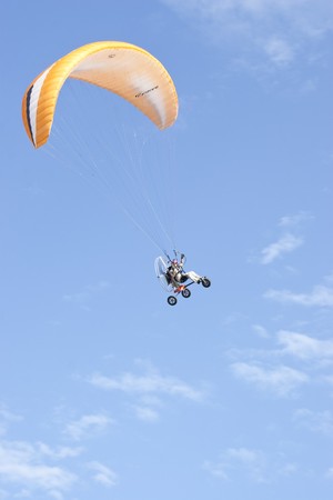 PUTRAJAYA, MALAYSIA - MARCH 21 : A Paragliding enthusiasts flying in blue sky during 2nd Putrajaya International Hot Air Balloon Fiesta March 21, 2010 in Putrajaya, Malaysia のeditorial素材