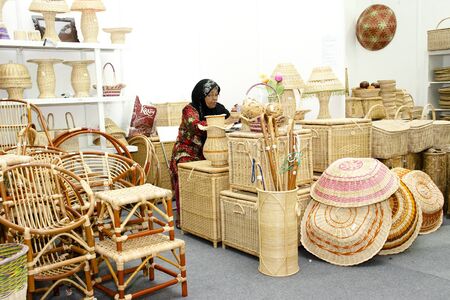KUALA LUMPUR, MALAYSIA - MARCH 4: An unidentified woman showcases a Malaysia rattan product during Malaysia National Craft Day 2011 on March 4, 2011 in Kuala Lumpur, Malaysiaのeditorial素材