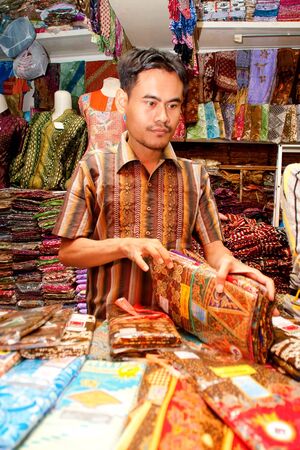 BANDUNG-JUNE 26 : Unidentified batik sellers at Pasar Baru Trade Centre prepare for customer on June 26, 2011 in Bandung, Indonesia. In 2009 UNESCO recognized batik as an Indonesian cultural treasure.のeditorial素材