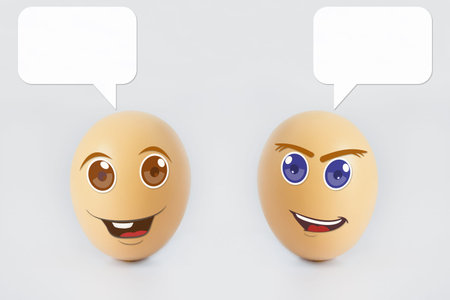 Two happy eggs with smiling faces representing emotional happiness with speech bubble for text...