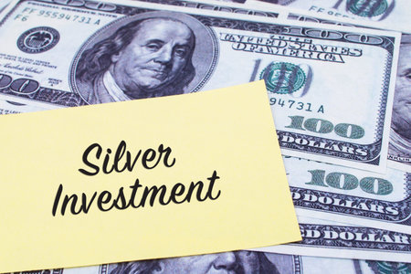Focus on the words Silver Investment written on a yellow paper with USD dollars currency as a background. Concepts of investment and business.の写真素材