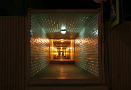 Long metal tunnel or passage in night