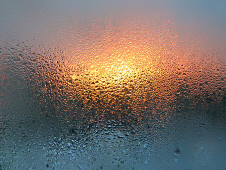 Water drops and sunlight on window glassの写真素材