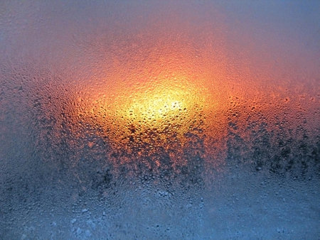 Water drops and sunlight on window glassの写真素材