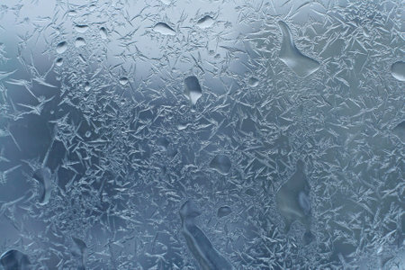 window glass with frost and water dropsの写真素材