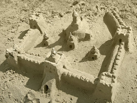 A big sandcastle with towers on the beachの写真素材