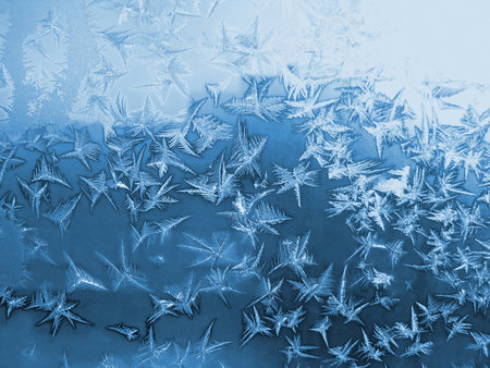 Ice pattern close-up on winter window glass, natural textureの写真素材