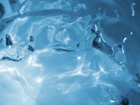 Blue ice and water close-up backgroundの写真素材