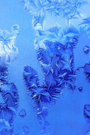 Ice pattern on winter window glass, natural textureの写真素材