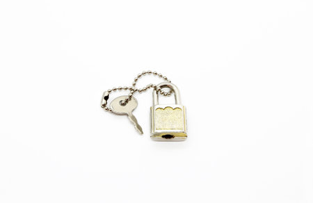 Small padlock and key for bag or suitcase isolated on white background