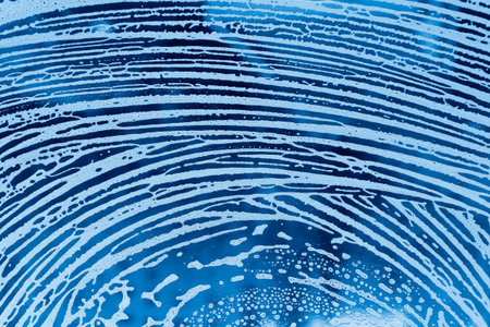 Blue background with pattern of natural soap foam