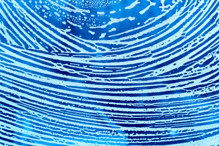 Blue background with pattern of natural soap foamの写真素材