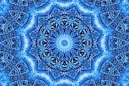 Blue background with concentric abstract pattern of soap foam on glass