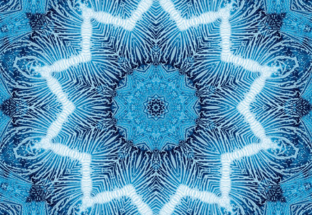Bright blue abstract concentric pattern with soap foam on glass