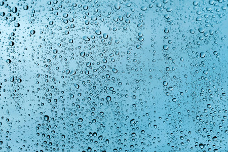 Water drops on glass, natural green texture