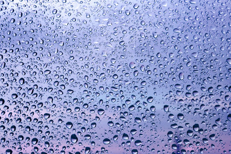 Water drops on glass, close-up natural texture