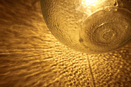 Abstract patch of reflected light of a glass lamp on the wall, shadow and light backgroundの写真素材