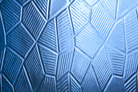 Glass with decorative abstract pattern, dark blue backgroundの写真素材