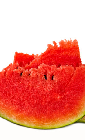 Pieces of ripe juicy red watermelon with seeds close-up isolated on white backgroundの写真素材