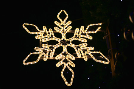 Beautiful christmas decoration on the streets of Europe, bright glowing snowflake