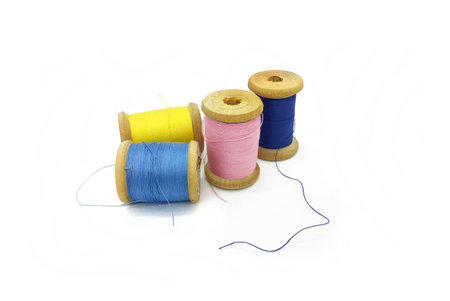 Spools of bright multi-colored threads isolated on a white background
