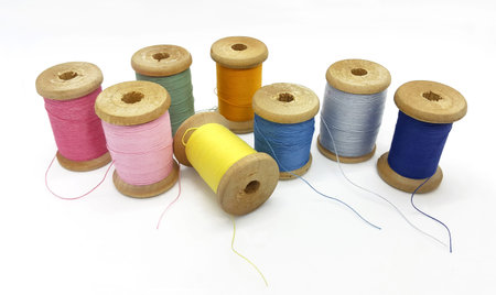 Spools of bright multi-colored threads isolated on a white background