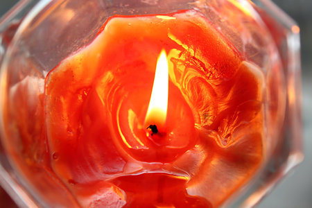 Closeup of orange burning candleの写真素材
