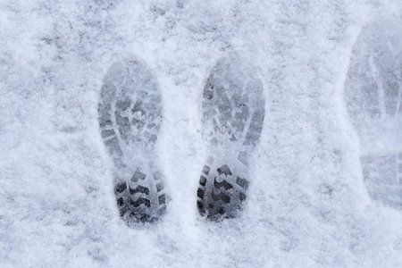 Marks of shoes in the snow background