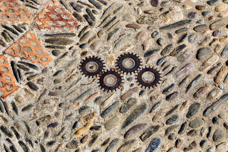 Unusual floor with pattern from pebbles, brick and rusty metal details in the park Montjuic, Barcelona, Catalonia, Spainの写真素材