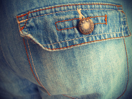 Fragment of close-up blue jeans with pockets, vintage effect backgroundの写真素材