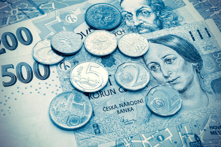 Money of Czech Republic, banknotes and coins on tourist map of Prague, travel toned background with vintage effectの写真素材