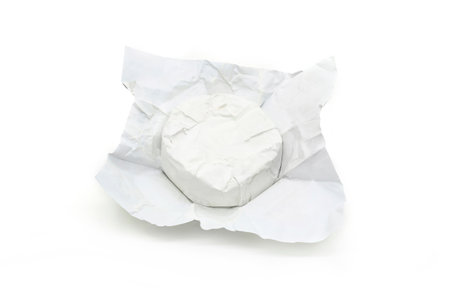 Soft cheese with white mold Brie in unwrapped packaging isolated on a white backgroundの写真素材