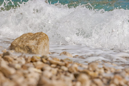 Powerful waves crushing on a rocky beach in Croatia. Wave splashes breaking on a stony shore. Scenic...