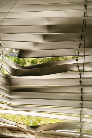Damaged Window Blinds with Broken Glass. Lost, decayed place. Abstract background. Window frame needs repair.の写真素材