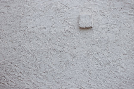 Wall fragment with scratches and cracks. Concrete cement wall texture with three dimensional elements. Modern design. Retro grunge style. Copy space.の写真素材