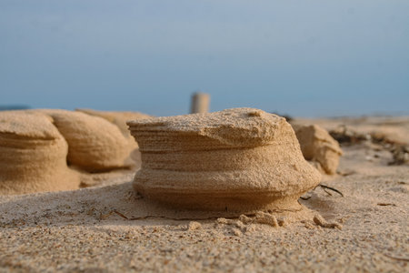 Natural sand sculptures made by wind on the Baltic sea beach. Gulf of Riga in Latvia Landscape. Blue sky and sea on the background. Copy space. Selective focus.の写真素材