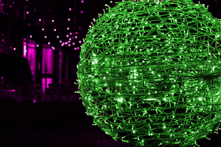 Closeup of intertwined blue neon string lights on the street. Crisscrossing glowing LED garland with small bright bulbs against dark background. Copy spaceの写真素材