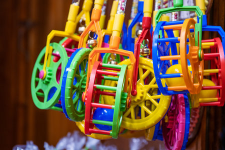 Multicolored baby walker wheels at Christmas market display. Colorful plastic trolley toys. Perfect xmas gifts for babies and little children. Holiday fair stall.の写真素材