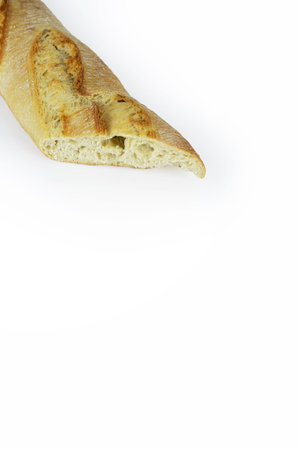 Closeup of a sliced French baguette with a crispy crust and airy texture isolated on a white background. With clipping path. Copy spaceの写真素材