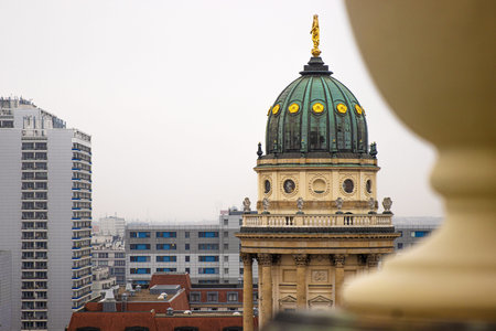 Berlin skyline with historical New German Catherdral and modern buildigs. Panoramic view of foggy Berlin from the rooftop of French Church on a misty day. Copy spaceの写真素材