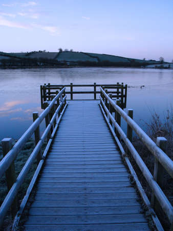 A pier on a freezing pre dawn morning in winter.の写真素材