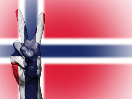 Hand showing the international symbol for peace, decorated in the national colors of Norwayの写真素材