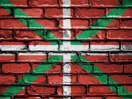 National Flag of Ikurrina on a Brick Wallの写真素材