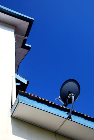 tv satellite dish on the blue sky backgroundの写真素材