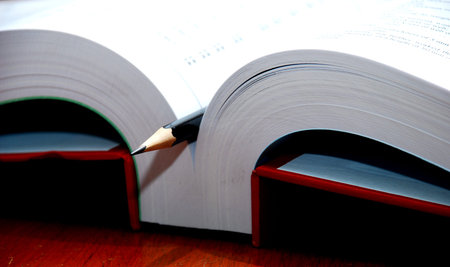 smart pencil with book on the wooden tableの写真素材